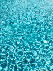 a blue pool with clear blue water