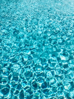 a blue pool with clear blue water