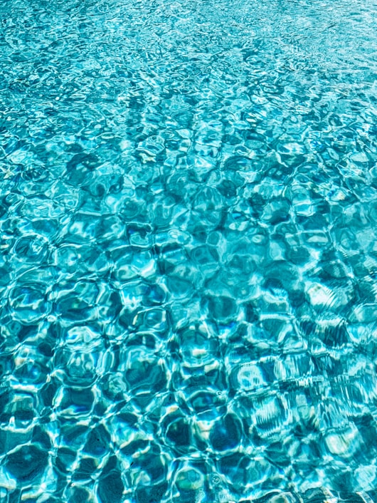 a blue pool with clear blue water