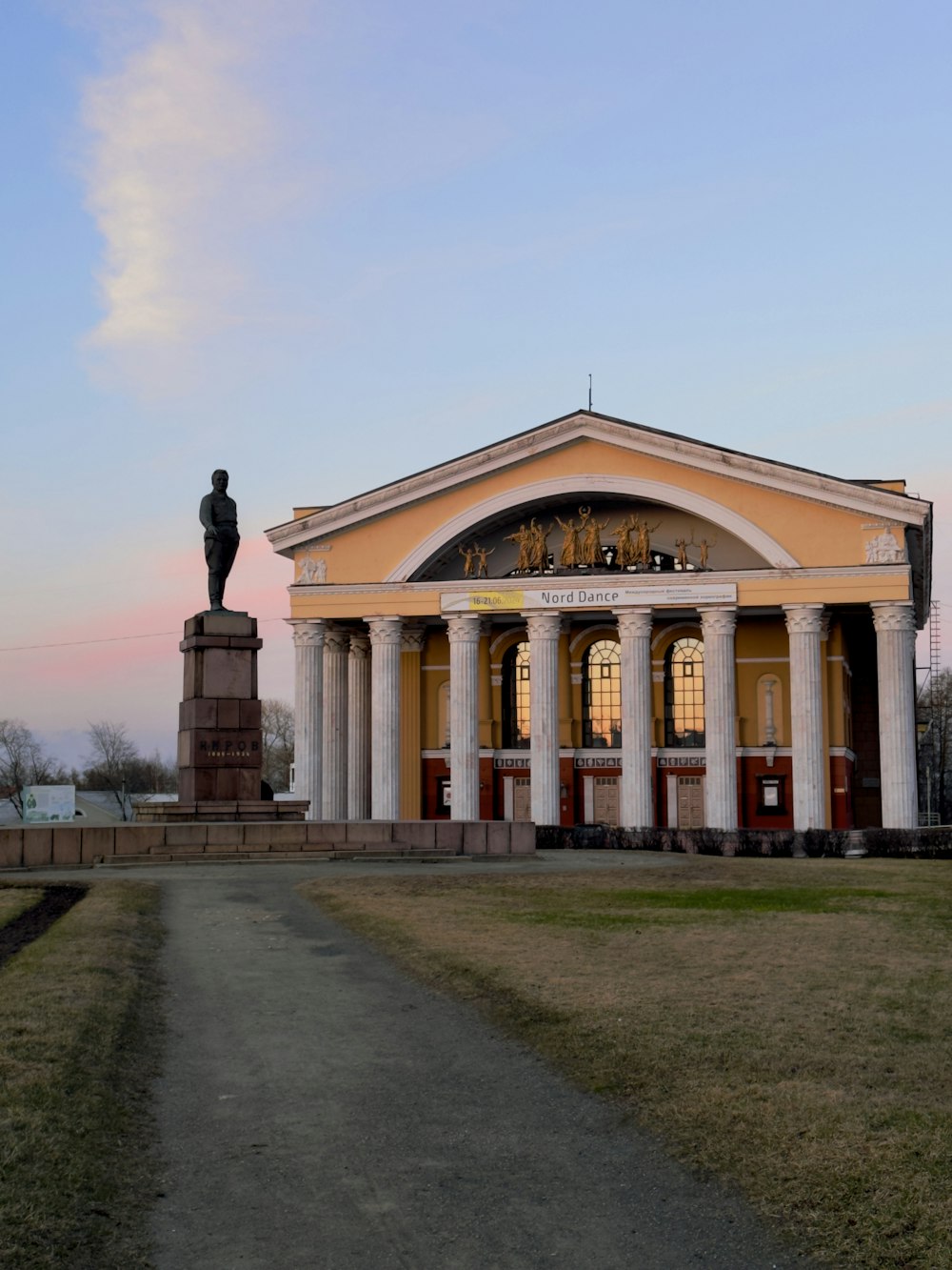 a large building with a statue in front of it