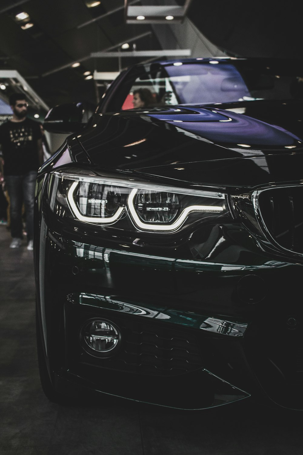 a black car is parked in a showroom