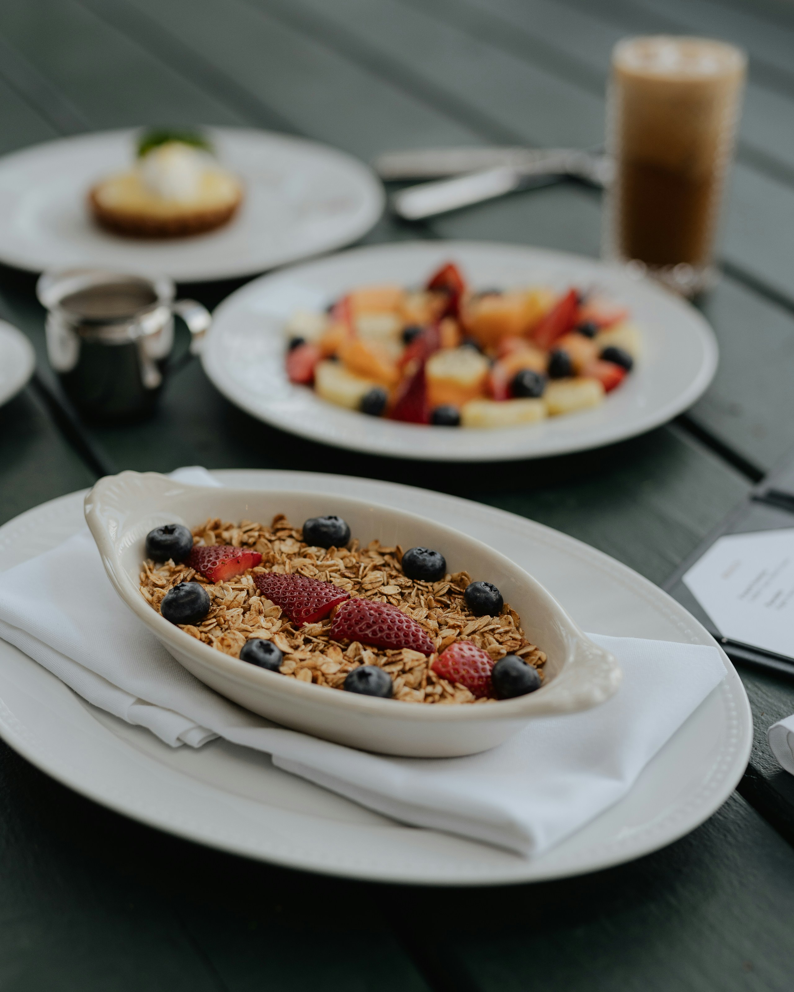 a table topped with plates and bowls of food