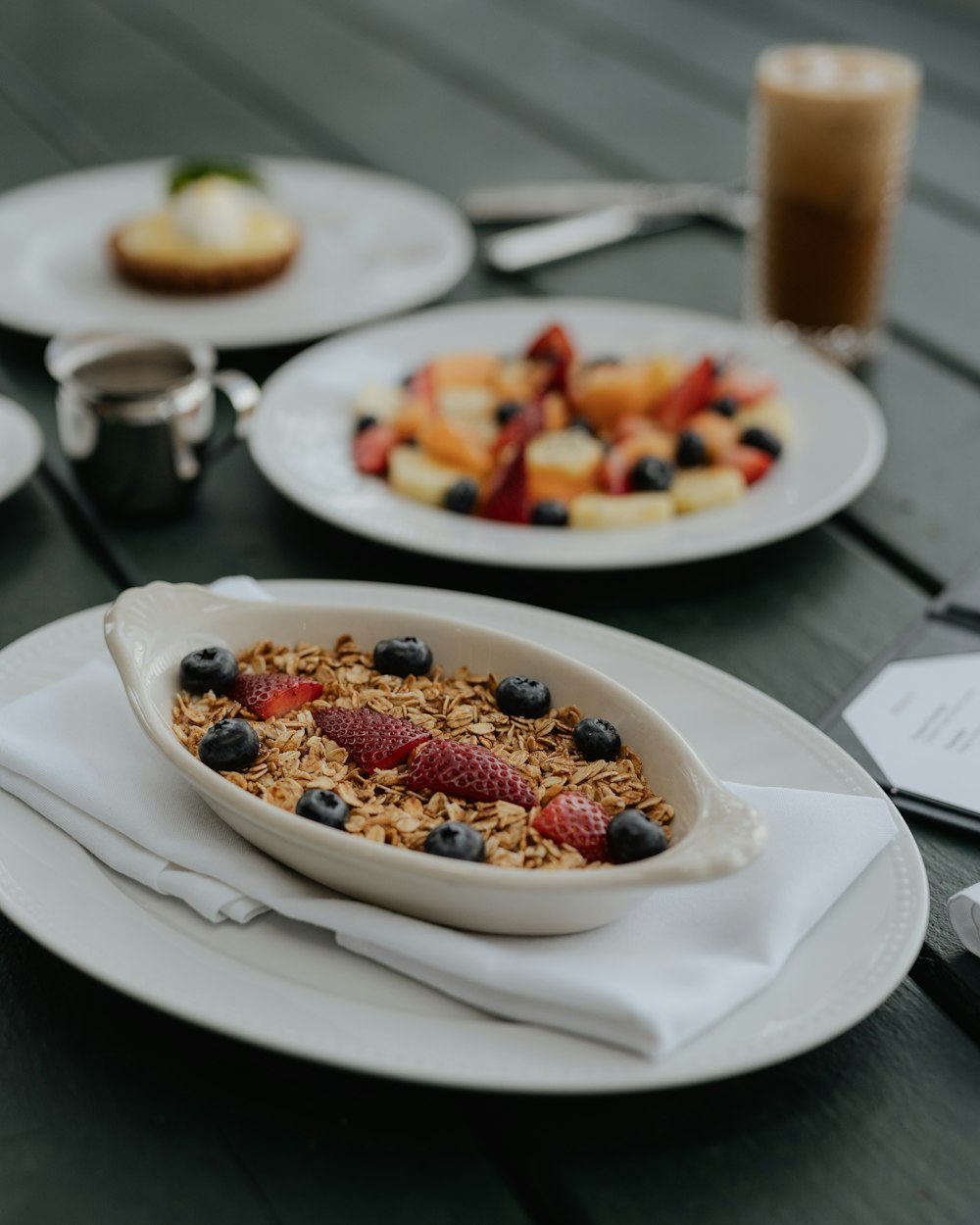 a table topped with plates and bowls of food