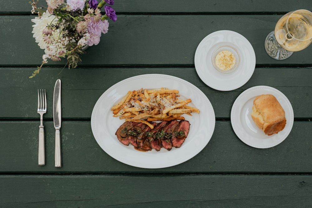 a plate of food and a glass of wine on a table