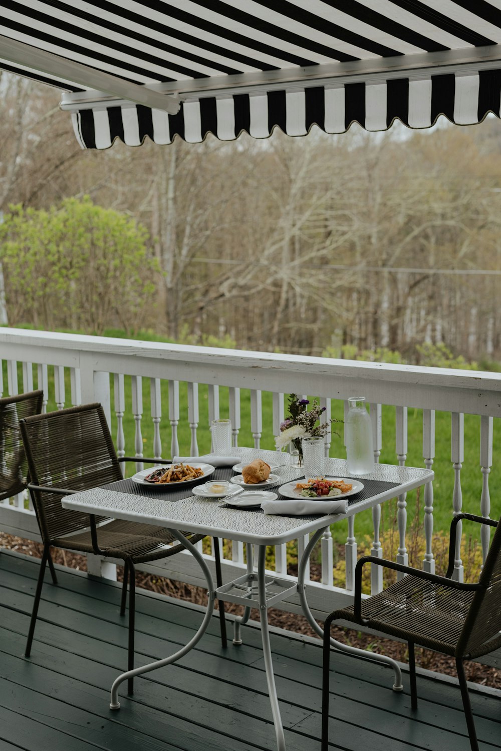 a couple of chairs sitting on top of a wooden deck