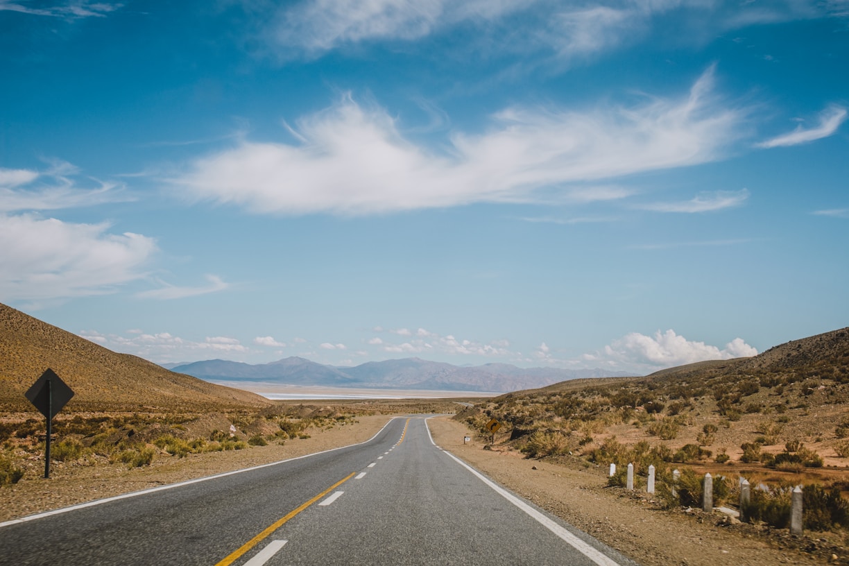 an empty road in the middle of a desert