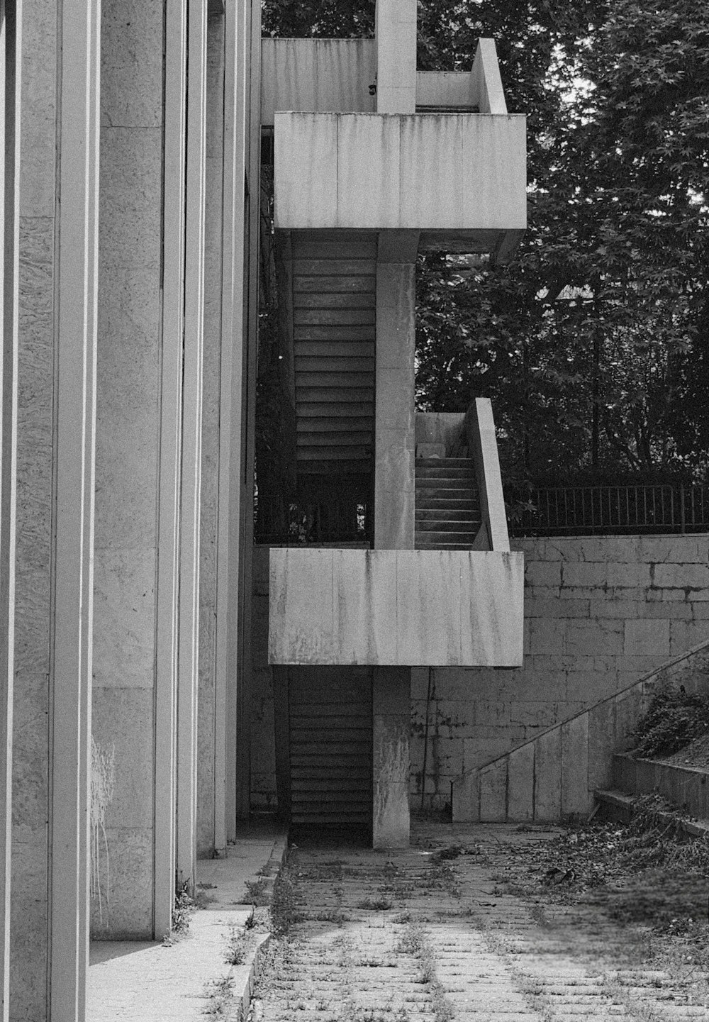 a black and white photo of a building with stairs