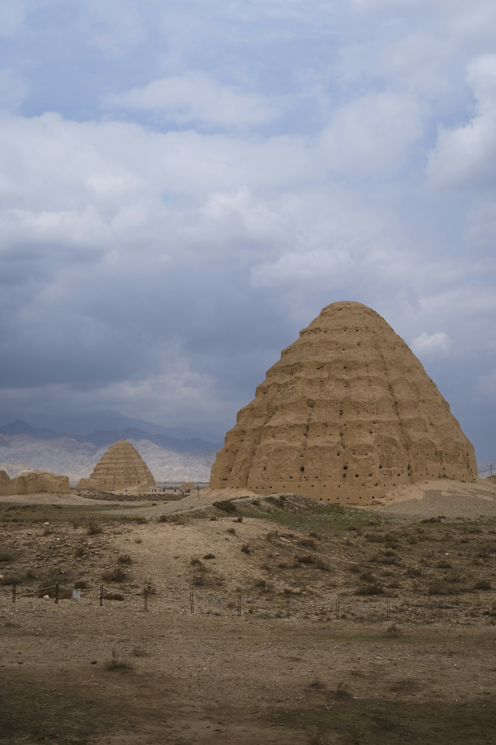 a large brown structure sitting in the middle of a desert