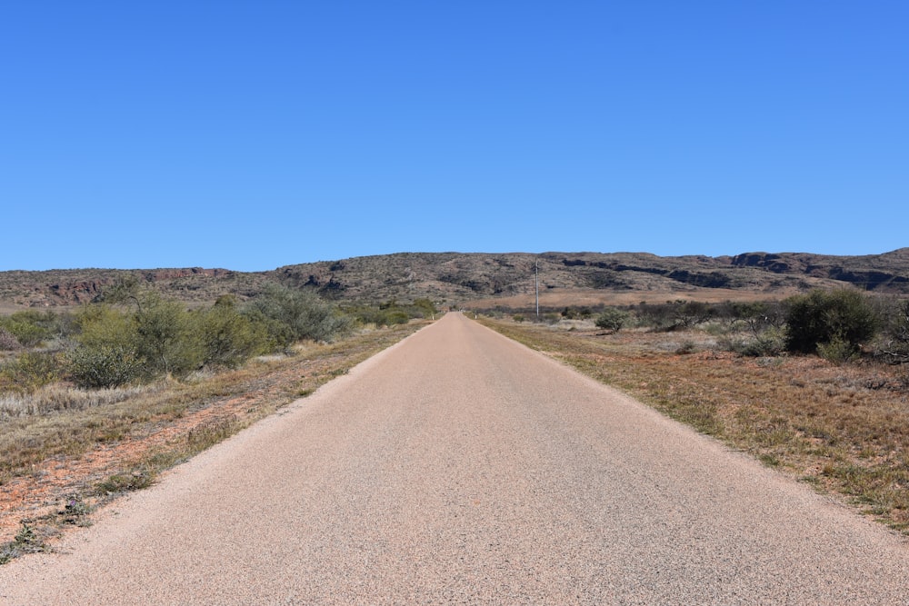 a dirt road in the middle of the desert