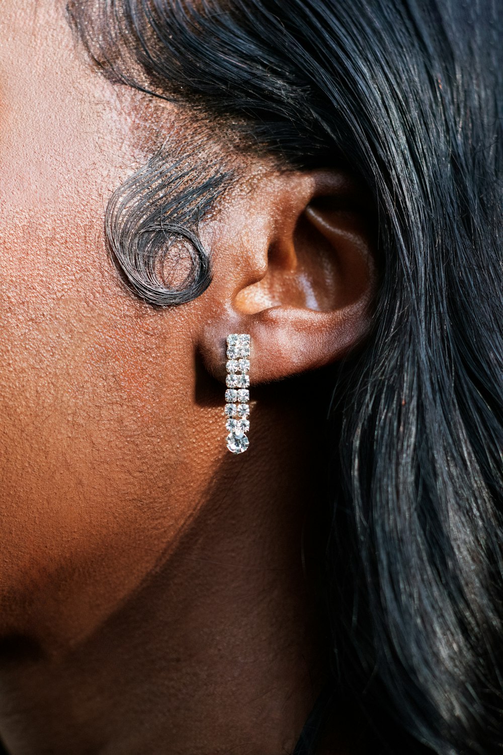 a close up of a person wearing a pair of earrings