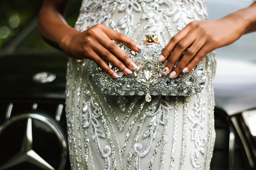 a close up of a person holding a purse