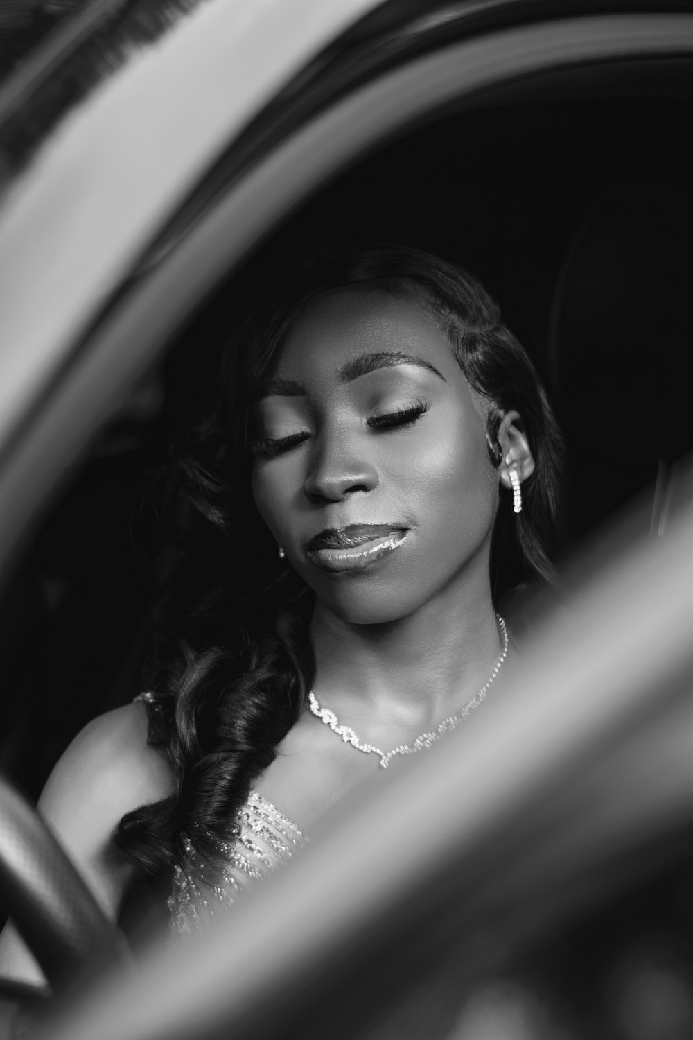 a woman sitting in a car with her eyes closed