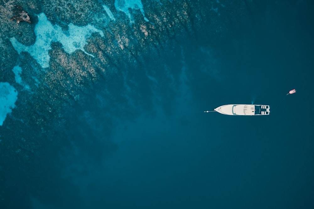 an aerial view of a boat in the ocean