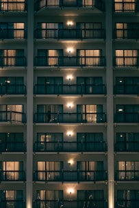 a tall building with many balconies lit up at night