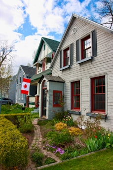 a white house with a canadian flag in front of it
