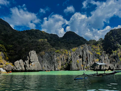 Limestone karsts and an outrigger boat in a Palawan lagoon
