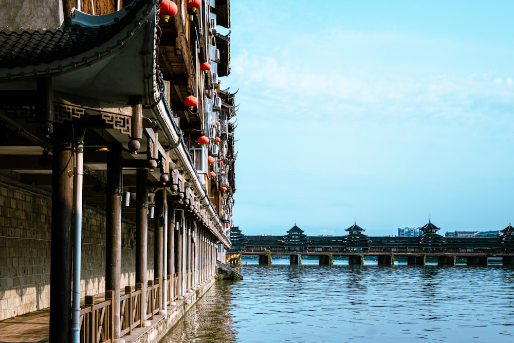 a bridge over a body of water next to a building