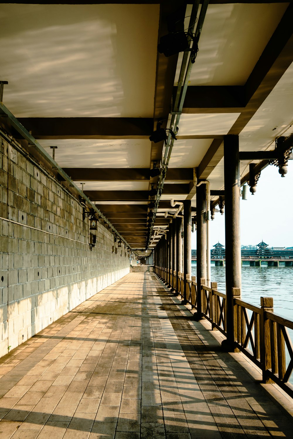 a long wooden walkway next to a body of water