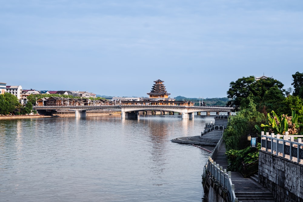 a bridge over a river with a building in the background