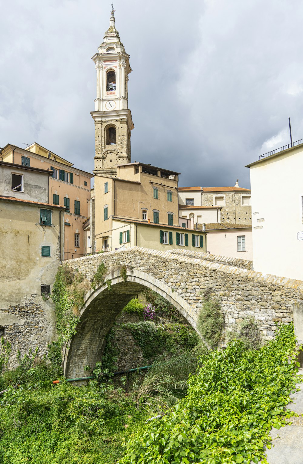 a stone bridge with a clock tower in the background