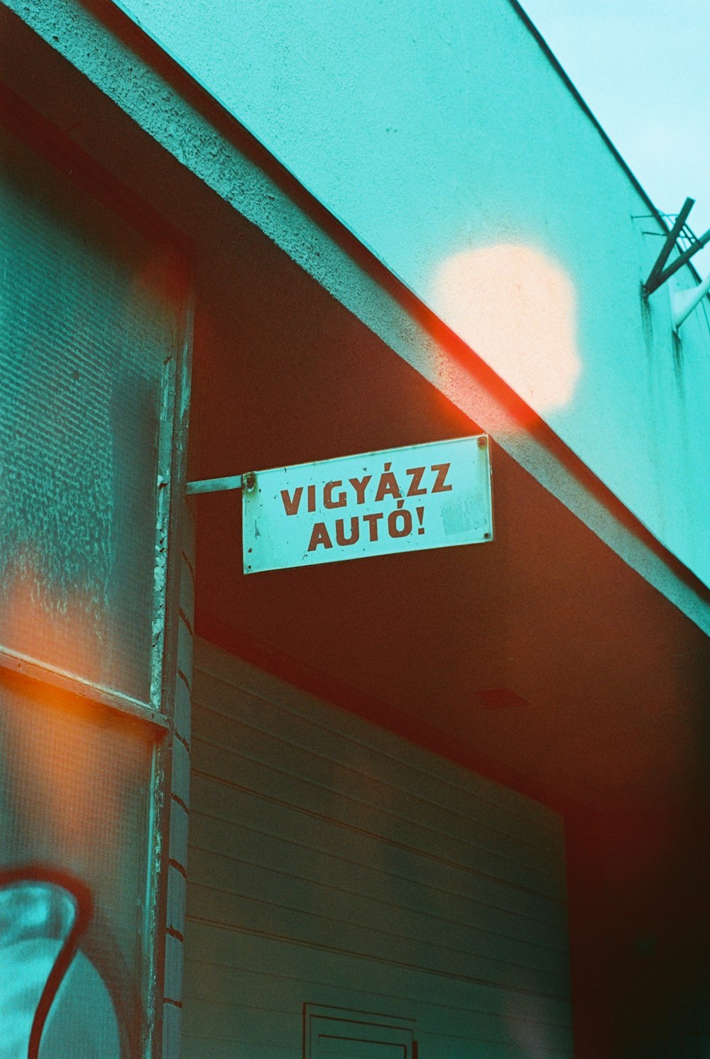 a street sign hanging from the side of a building