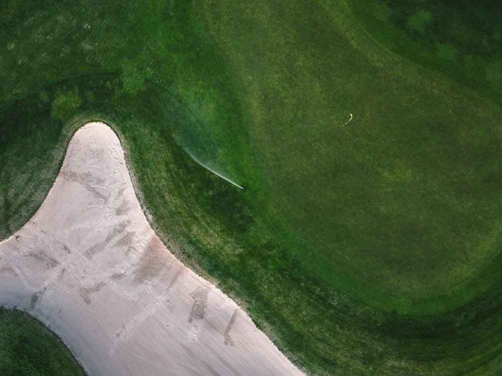 an aerial view of a green golf course