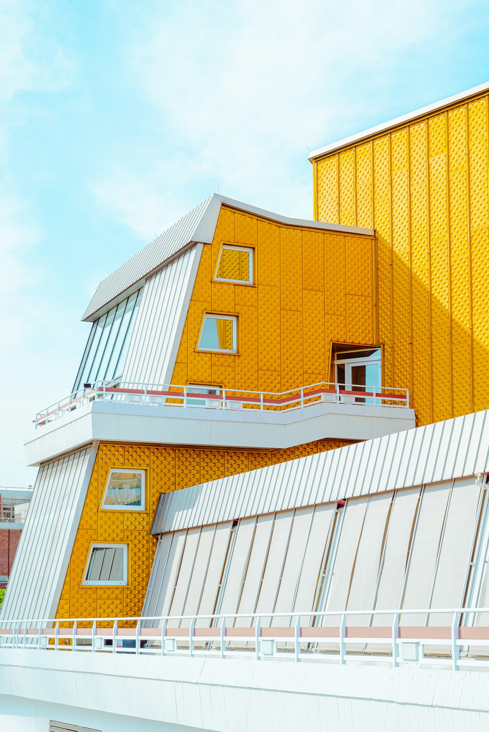 a yellow building with a clock on the side of it