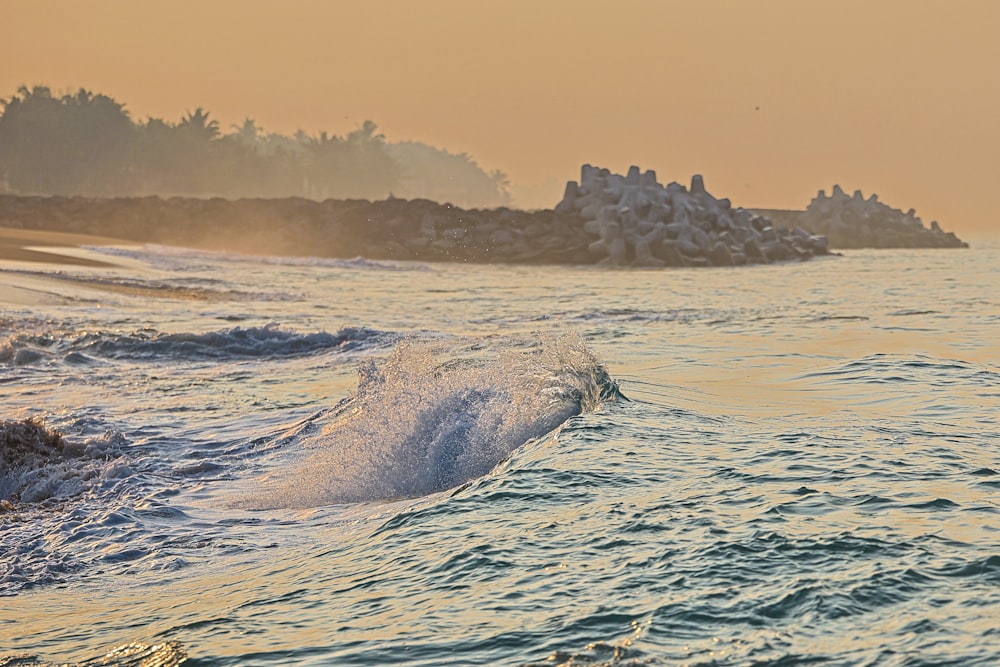 a person riding a surfboard on a wave in the ocean