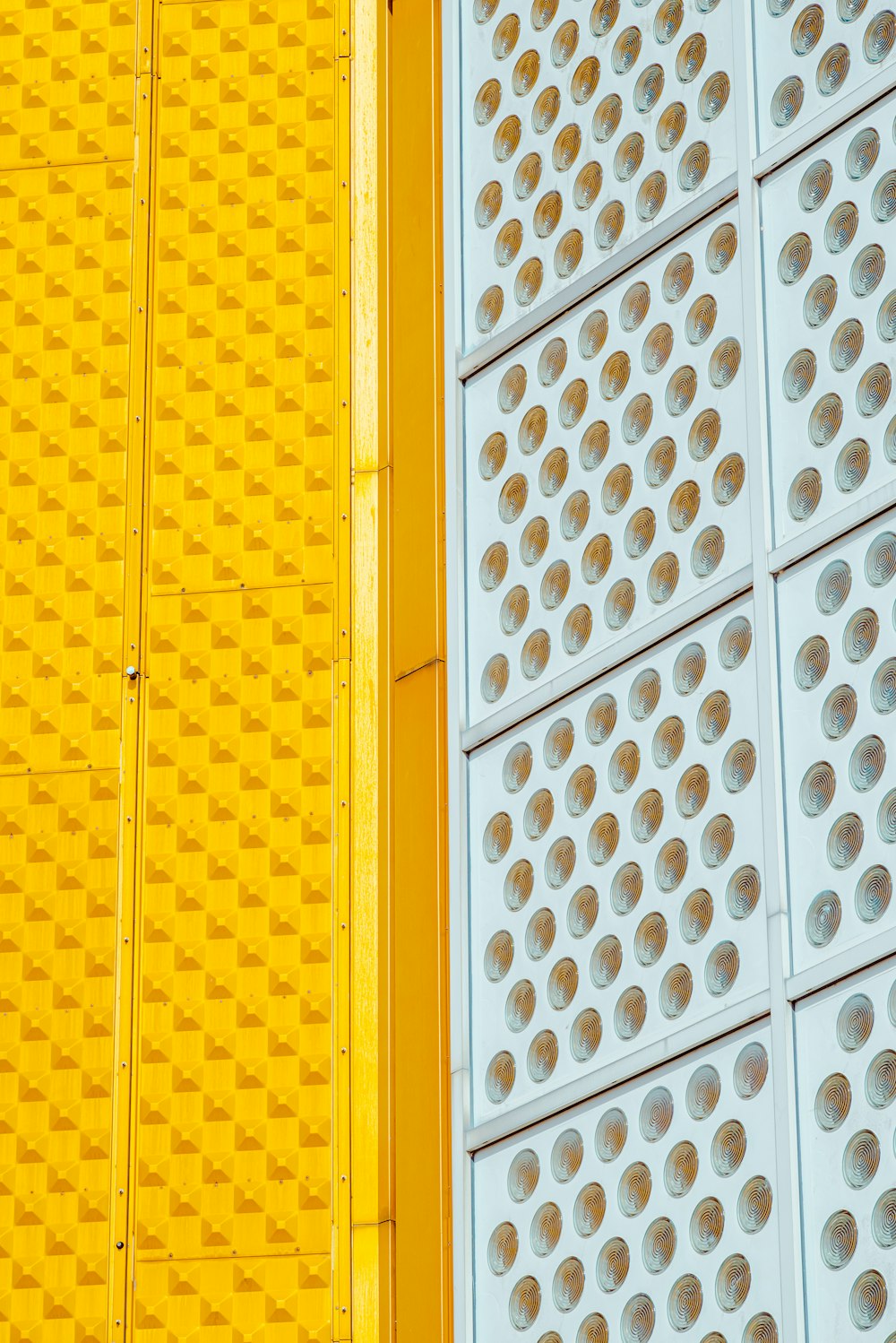 a close up of a yellow and a white wall