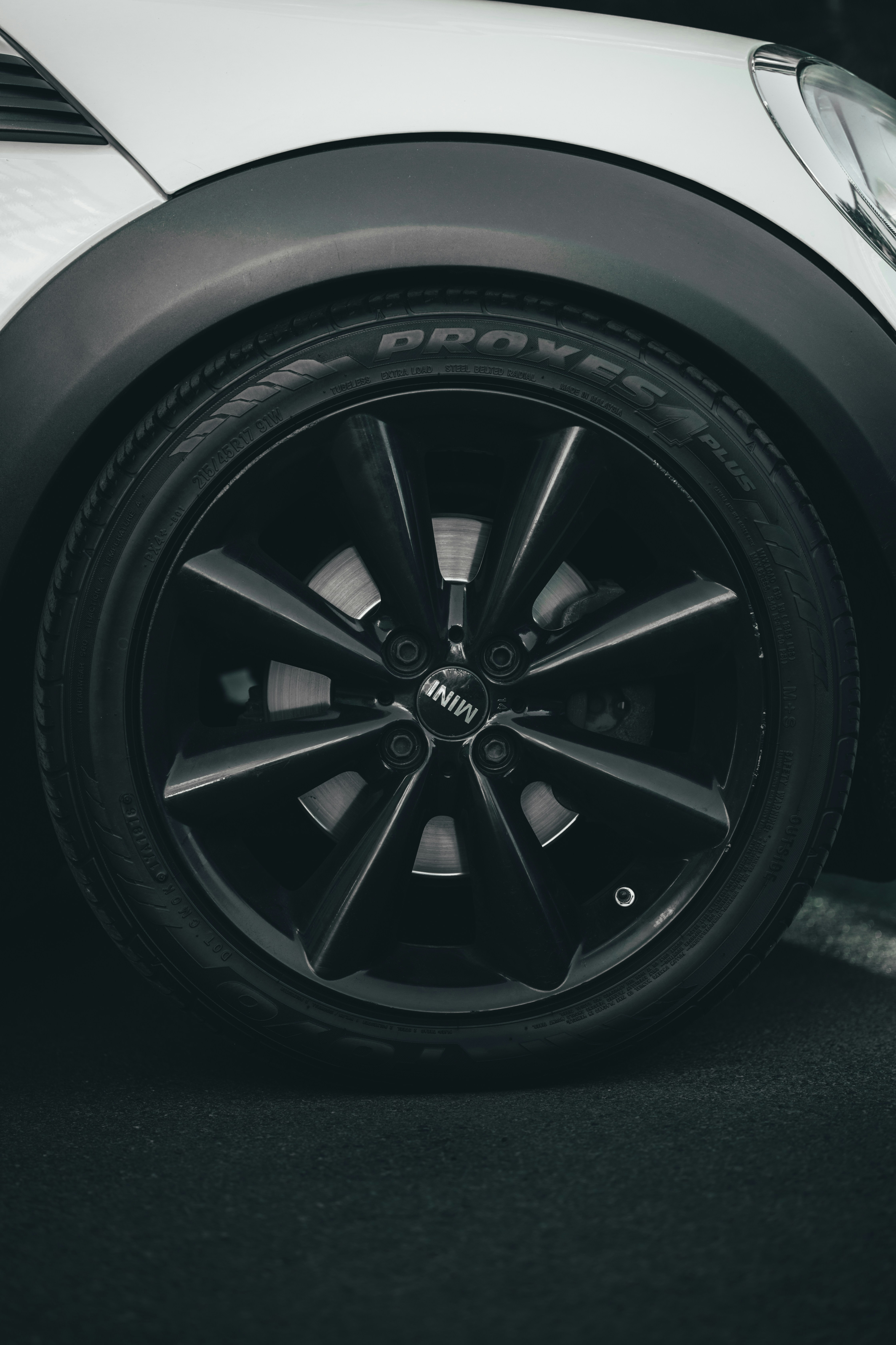 a black and white photo of a car wheel