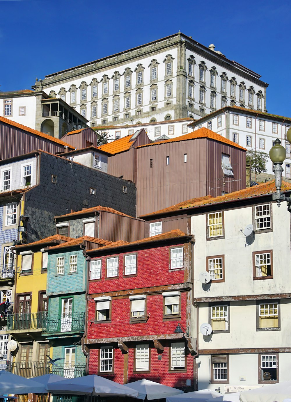 a group of buildings with a clock tower in the background