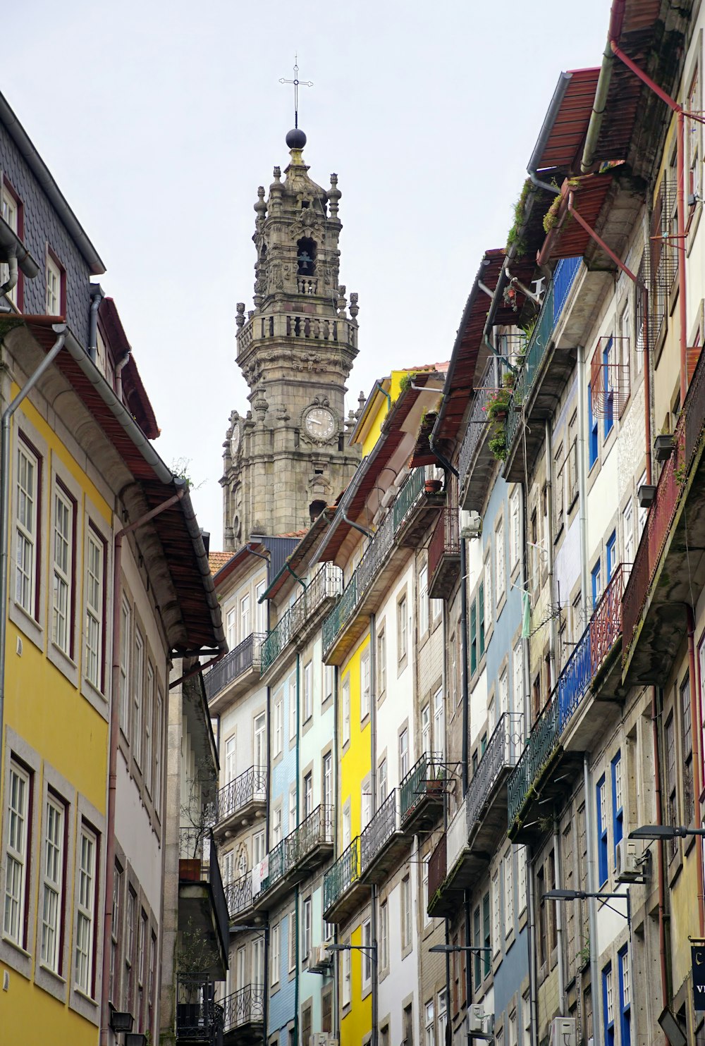 a tall clock tower towering over a city filled with tall buildings