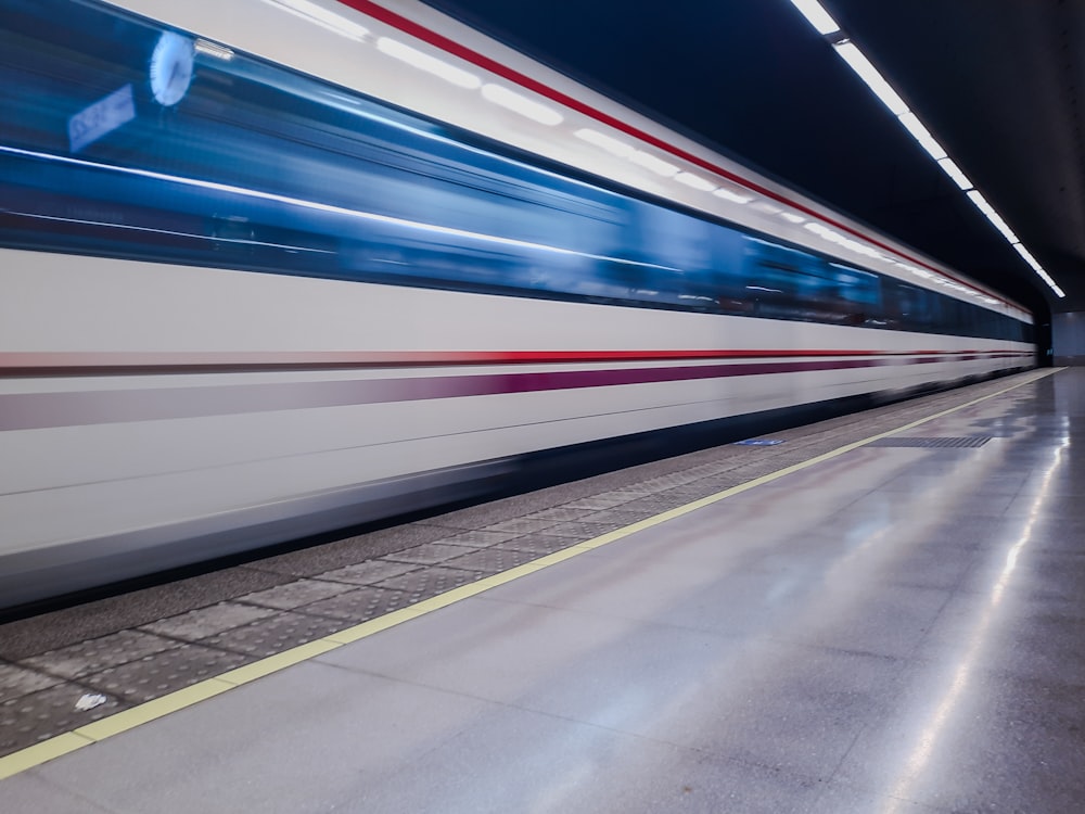 a subway train speeding through a subway station