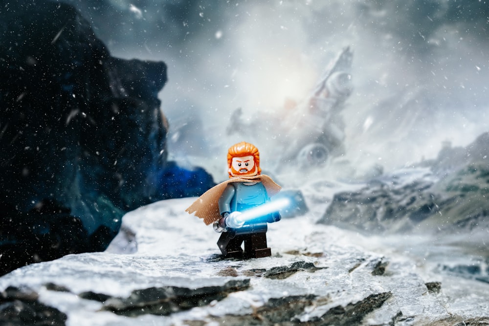 a lego star wars character standing on top of a snow covered mountain