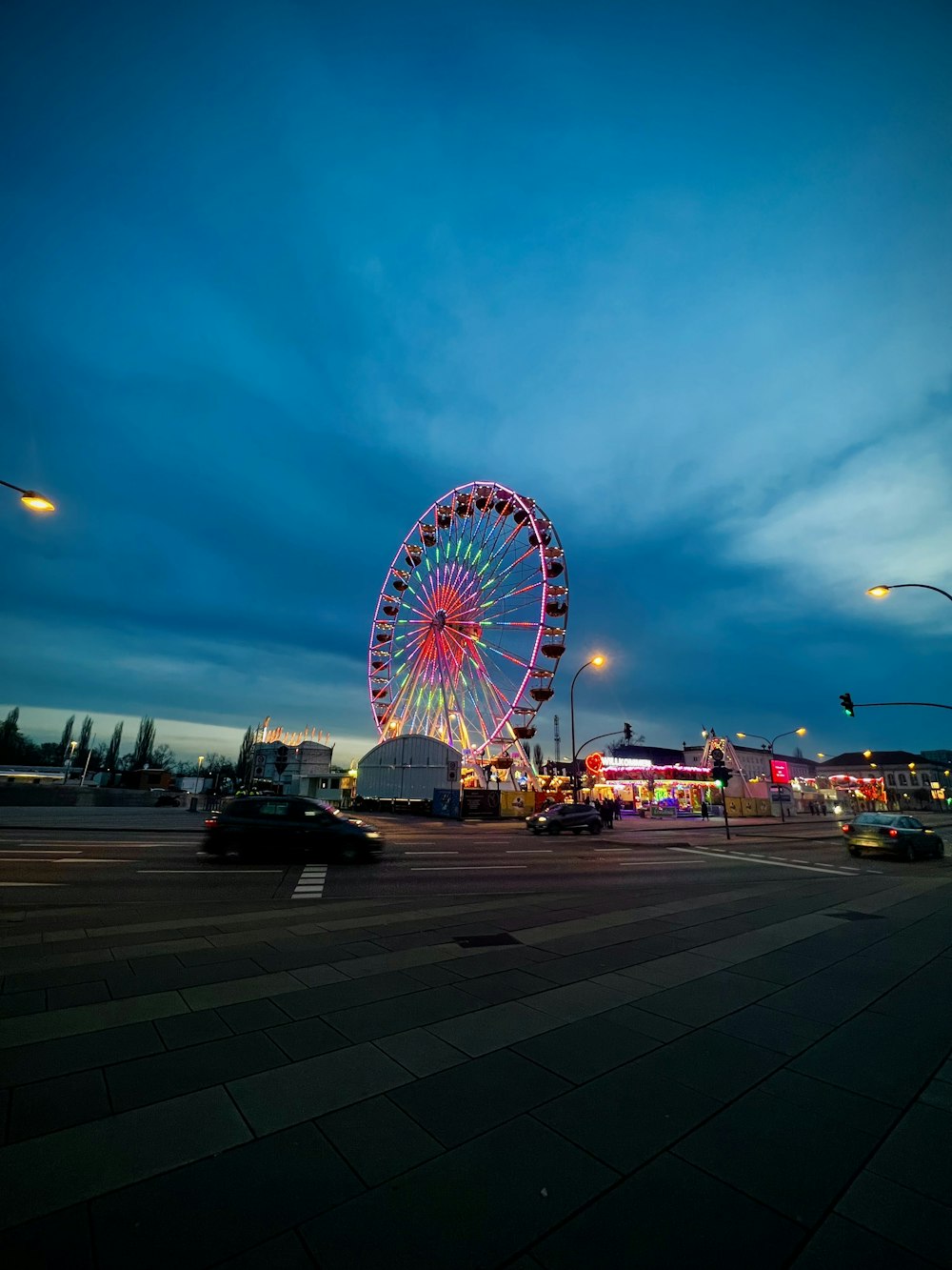 a large ferris wheel sitting on top of a parking lot