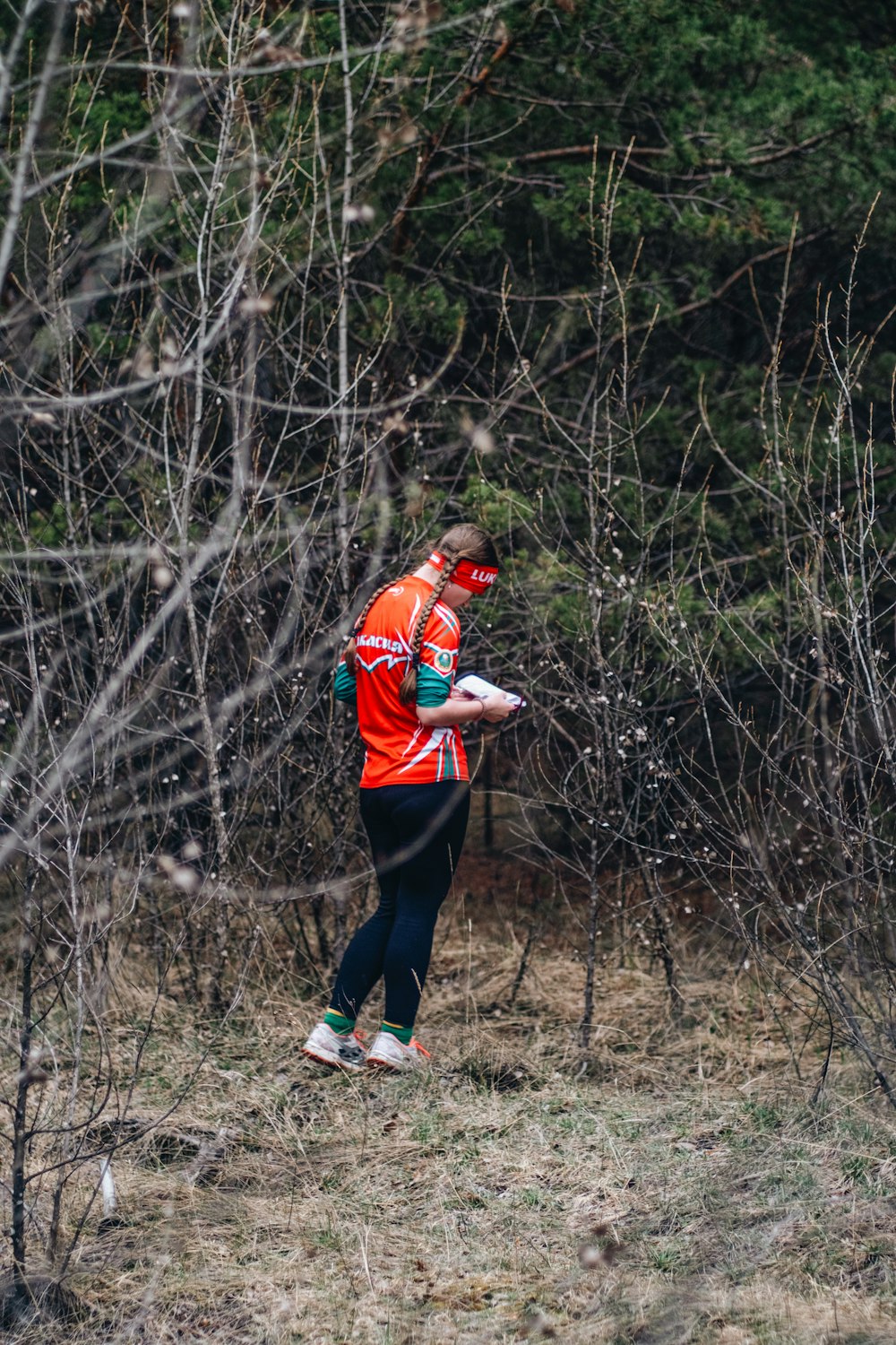 a man in an orange shirt is throwing a frisbee