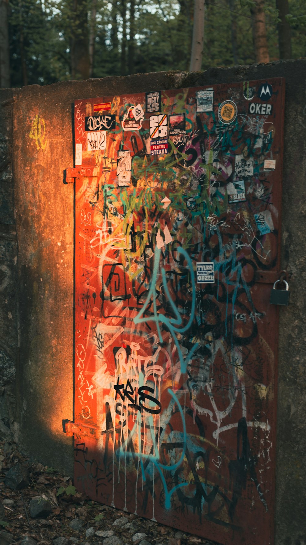 a rusted metal box covered in graffiti