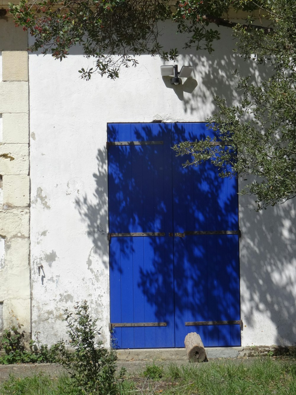 a white building with a blue door and window