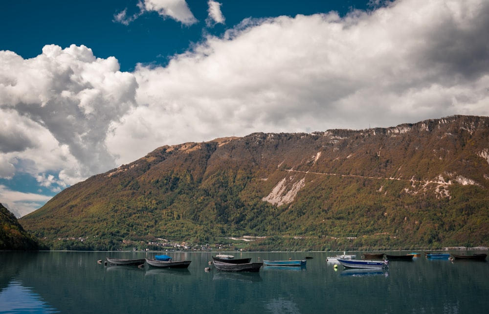 a group of boats floating on top of a lake