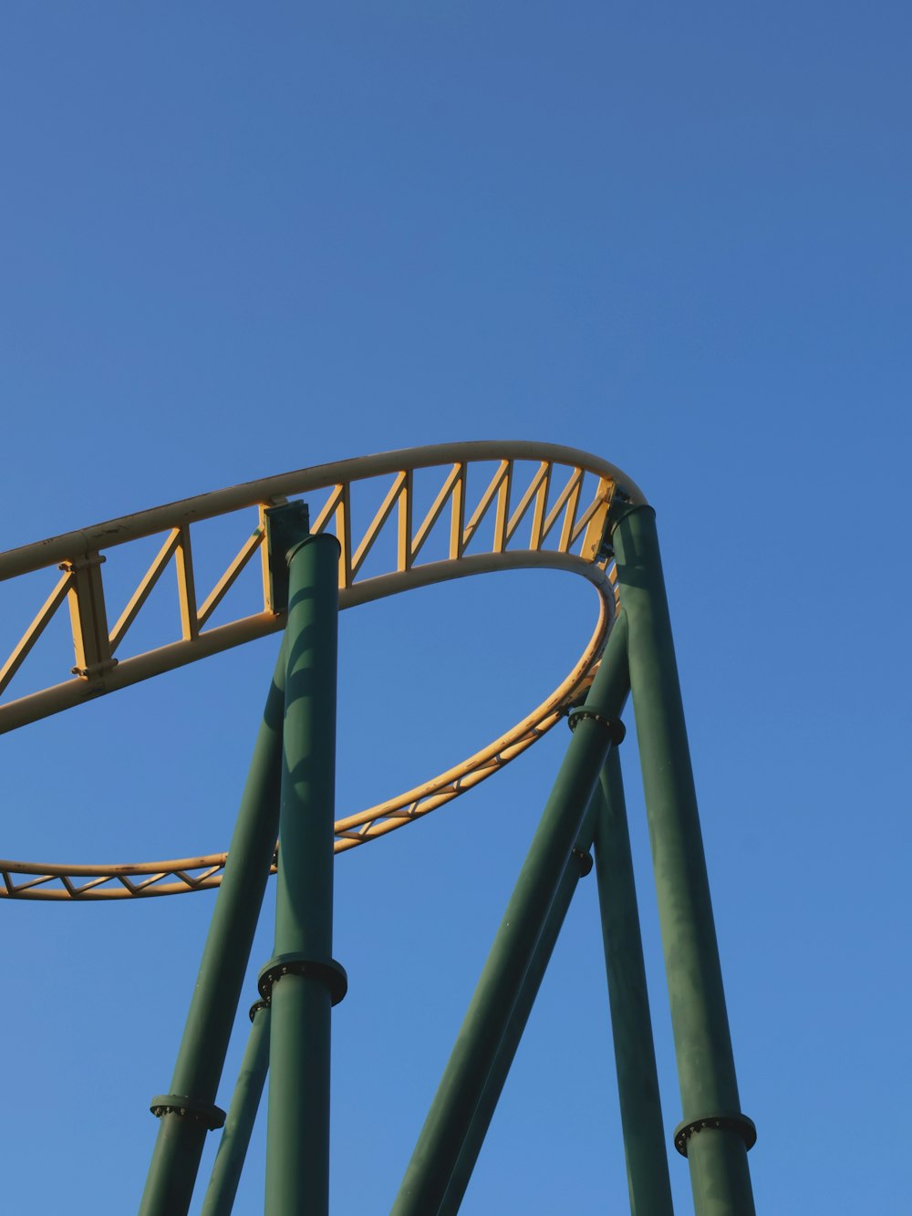 a roller coaster with a blue sky in the background