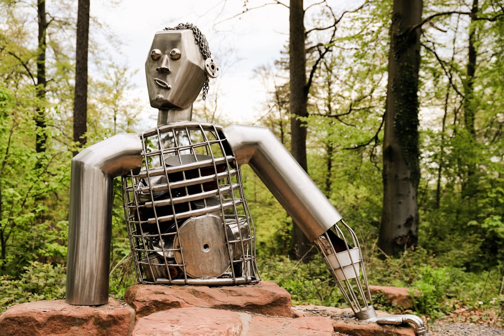 a sculpture of a robot with a cage on its back