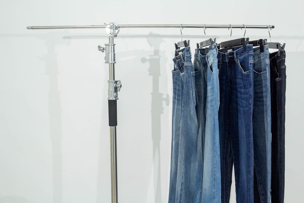 a pair of jeans hanging on a clothes rack