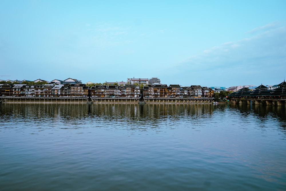 a body of water with houses in the background