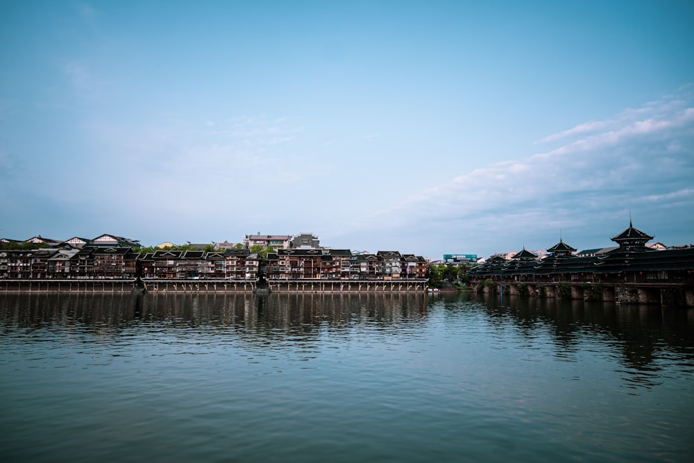 a large body of water with buildings in the background