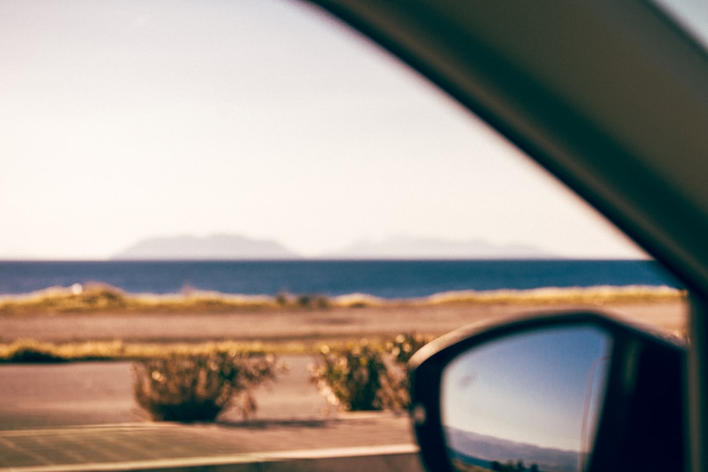 a view of the ocean from inside a car