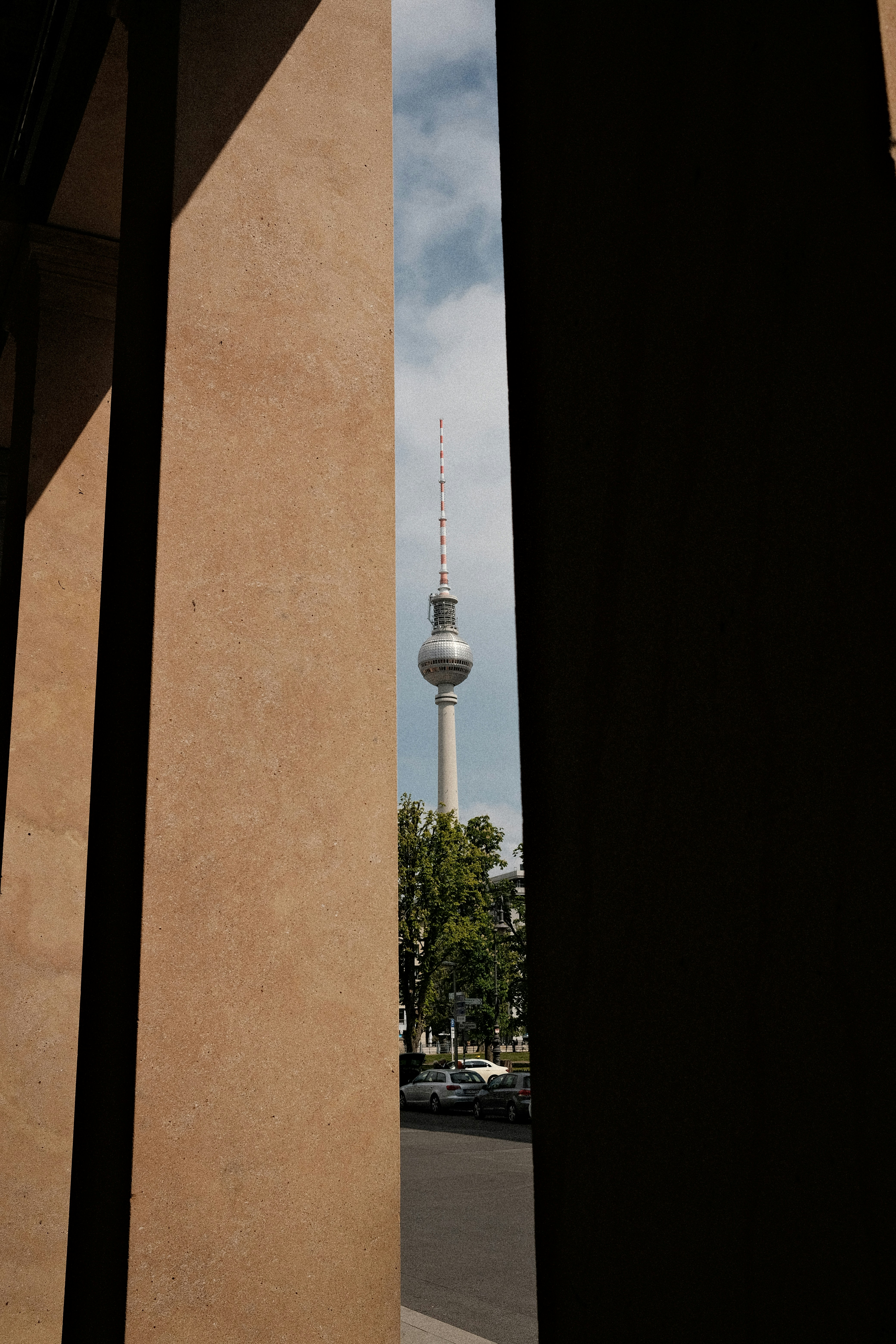 A view of a tall tower from between two buildings photo – Free Tower ...