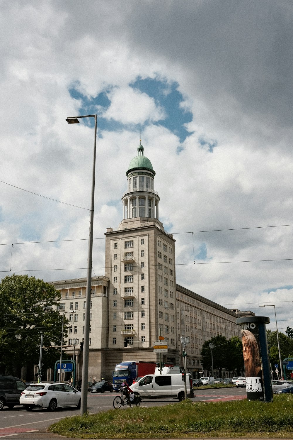 a tall building with a green dome on top