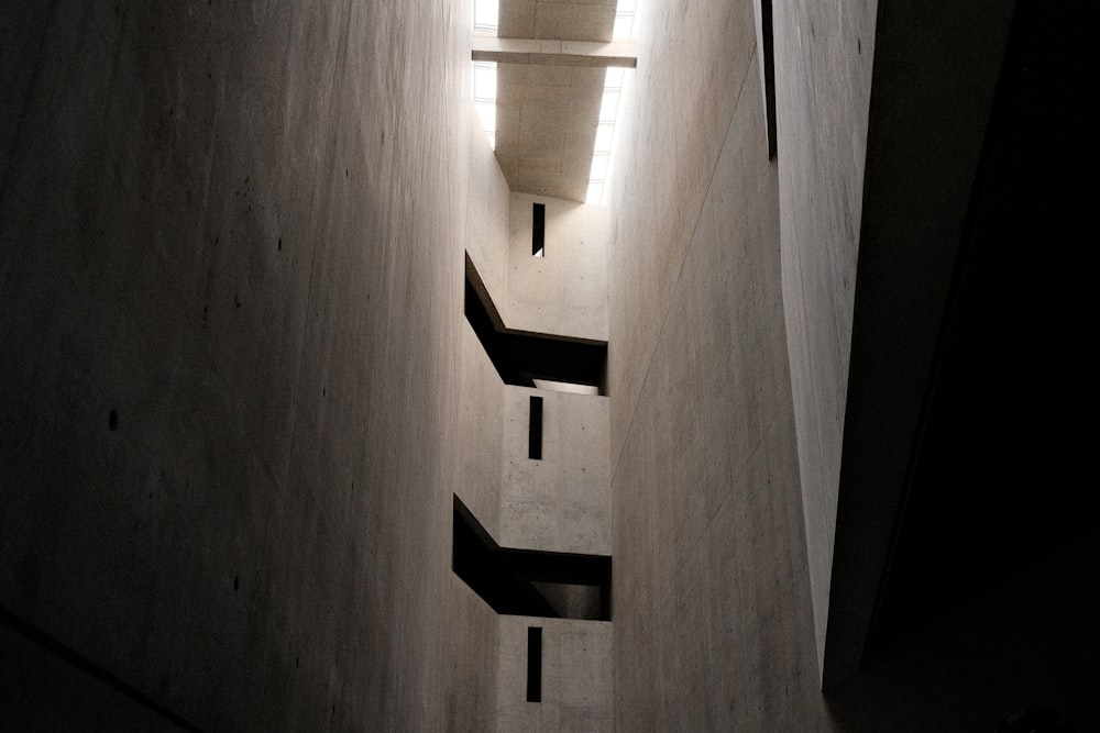 a narrow hallway with a light on the side of it