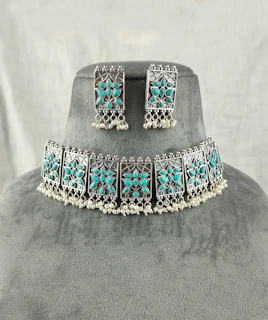 a necklace and earring set with turquoise stones