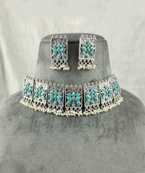 a necklace and earring set with turquoise stones